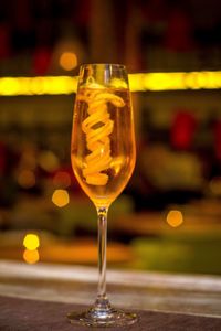 Close-up of wine glass on wooden table