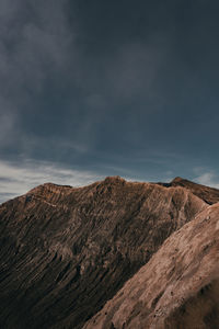 Scenic view of mountains against cloudy sky