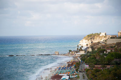 High angle view of sea and buildings against sky