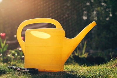 Close-up of yellow mailbox on field