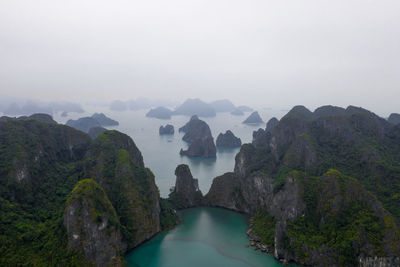 Scenic view of sea and mountains against sky