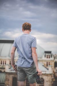 Full length of man standing against sky in city