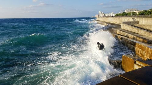 High angle view of waves in sea against sky