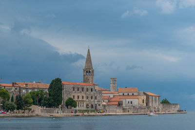 Buildings against cloudy sky