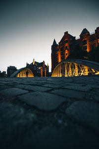 Illuminated buildings against sky in city