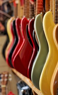 Colorful guitar in row for sale