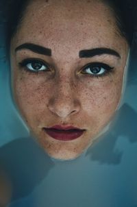 Directly above portrait of woman in water