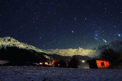 Scenic view of illuminated mountain against sky at night