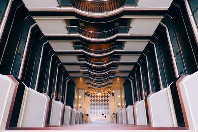 Low angle view of empty corridor along buildings