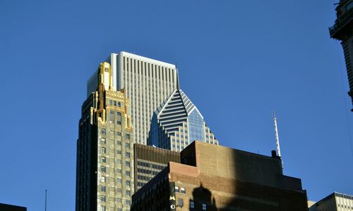 Low angle view of skyscraper against clear blue sky