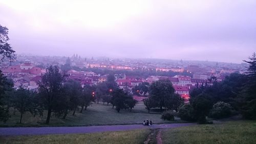 View of cityscape against cloudy sky