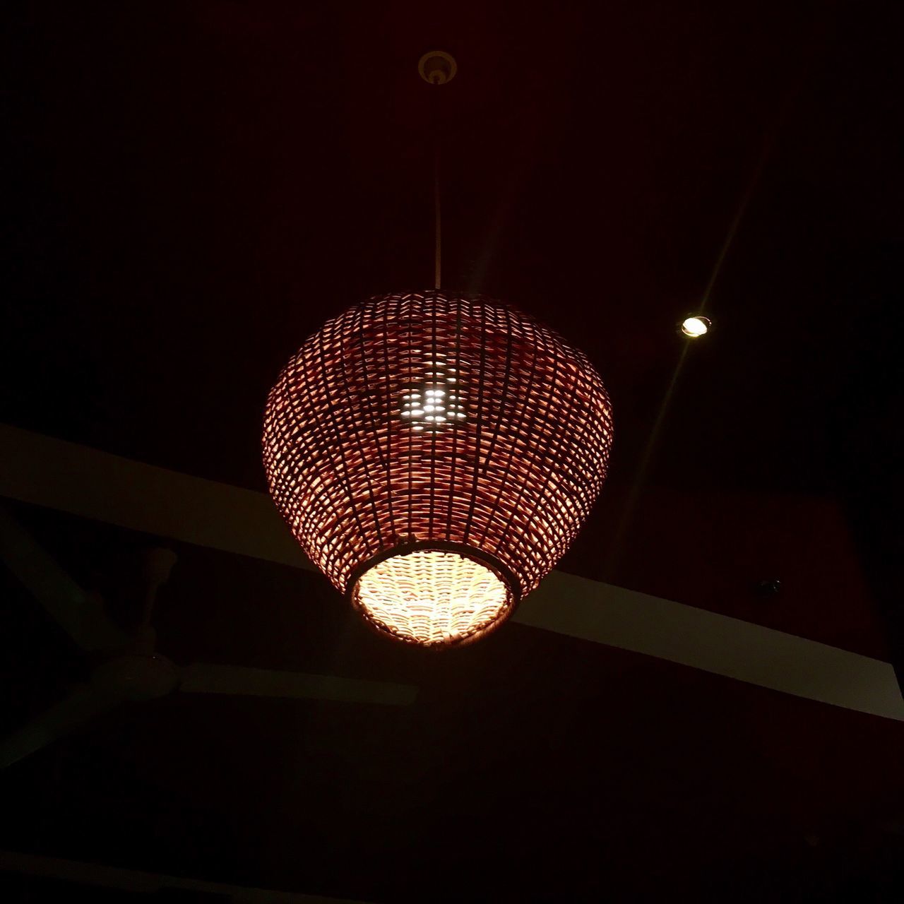 LOW ANGLE VIEW OF ILLUMINATED PENDANT LIGHTS HANGING FROM CEILING