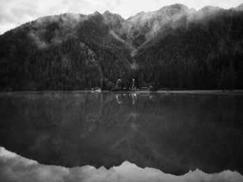 Scenic view of lake by mountains against sky