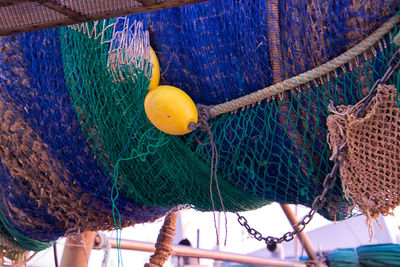 Close-up of fishing net hanging on rope