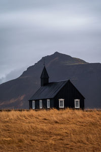 House on field against sky