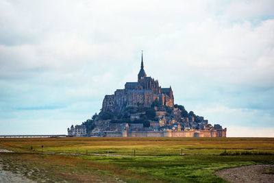 View of temple against cloudy sky