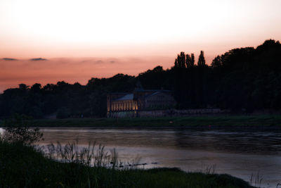 Scenic view of lake against sky during sunset