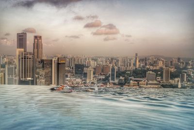 Early morning swim in the sky pool , marina bay sands hotel, overlooking city of singapore 