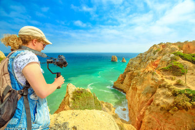 Woman looking at sea against sky