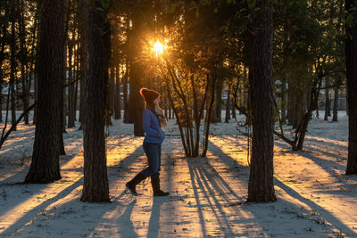 Full length of woman standing in forest