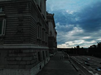 Buildings in city against cloudy sky