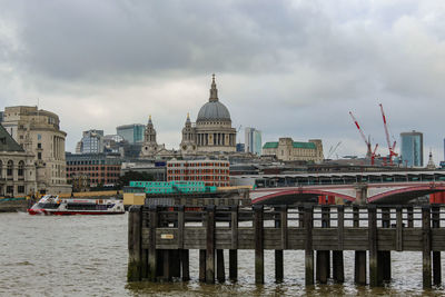 View of cityscape against cloudy sky