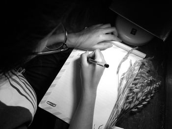 High angle view of woman reading book