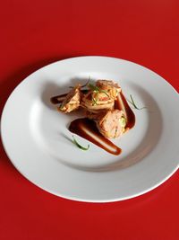 Close-up of food in plate on red background