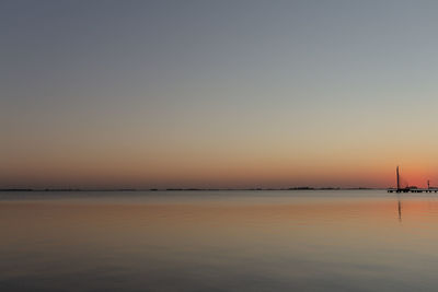 Scenic view of sea against clear sky at sunset