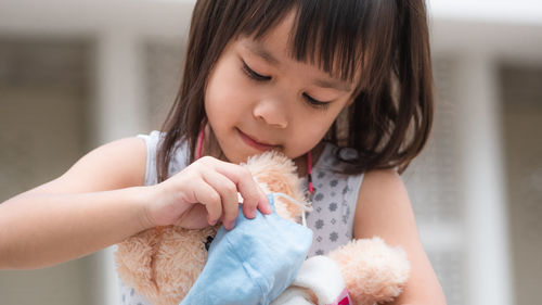 Close-up of cute girl holding toy