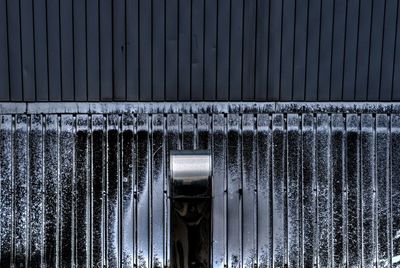 Close-up of metal fence against wall