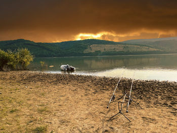 Scenic view of lake against sky during sunset