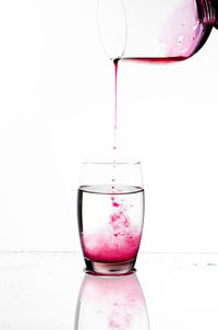 Close-up of beer in glass against white background