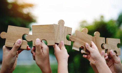 Cropped hand of man holding wooden blocks