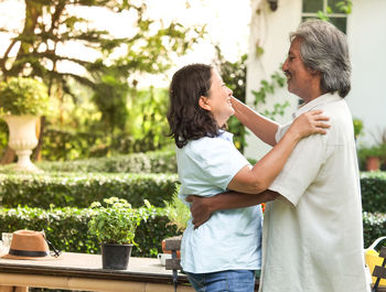 Mature couple dancing while standing in yard