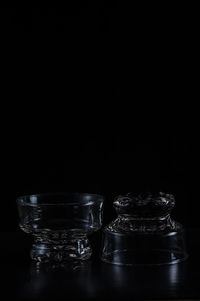 Close-up of glass bowls against black background