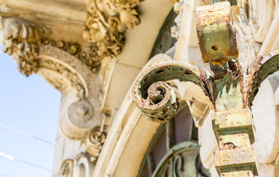 Close-up of rusty metal against building