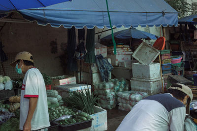 Midsection of man standing at market stall