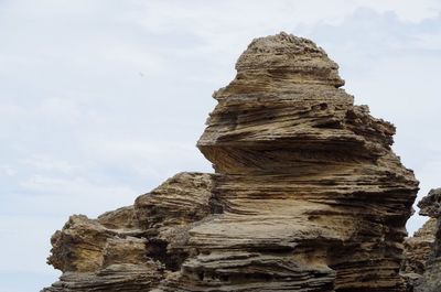 Low angle view of rock formations against sky