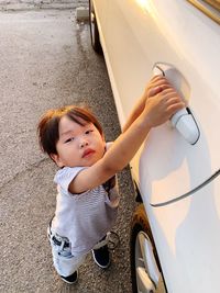 High angle view of cute baby girl in car