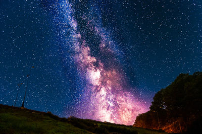 Low angle view of fireworks against sky at night