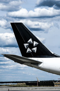 Low angle view of airplane flying against sky