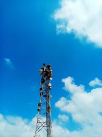 Low angle view of communications tower against sky