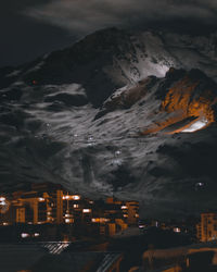 Illuminated buildings in city against sky at night