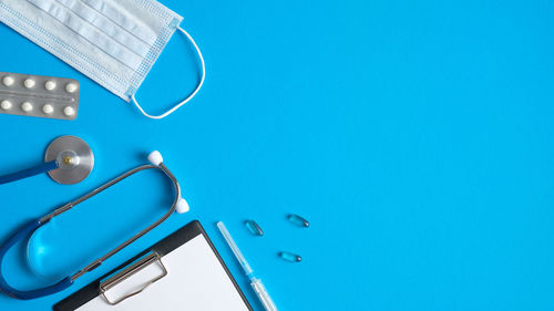 High angle view of lighting equipment on table against blue background