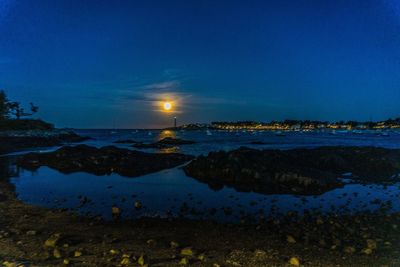 Scenic view of sea against sky at night