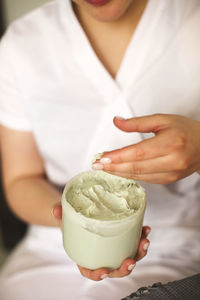 Midsection of woman holding ice cream in bowl