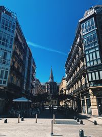 Buildings in city against blue sky