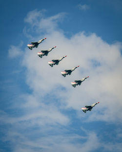 Low angle view of airshow against sky