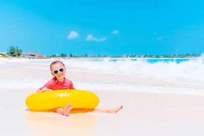 Portrait of man wearing sunglasses on beach